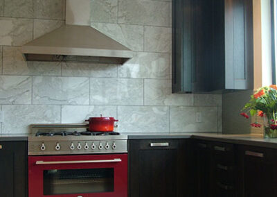 kitchen with red oven, dark cabinets