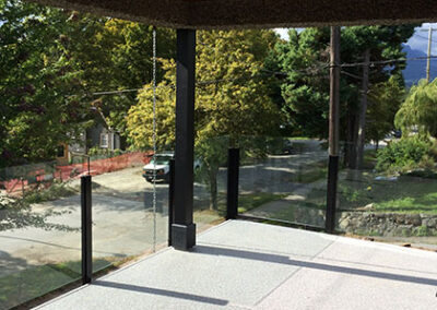 New covered patio with glass railings
